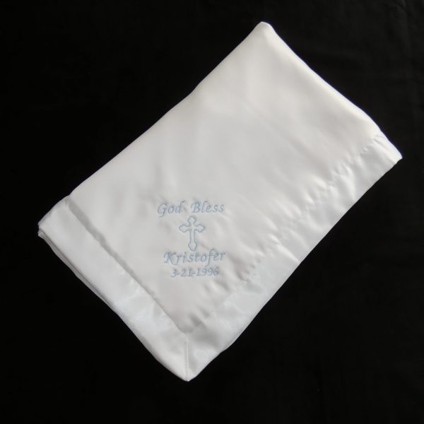 White Orthodox baptismal blanket with blue embroidery in English script.