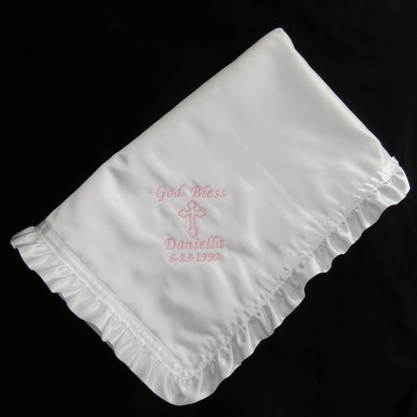 White Orthodox baptismal blanket with pink embroidery in English script, with a ruffled edge..