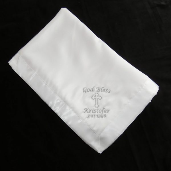 White Orthodox baptismal blanket with silver embroidery in English script.