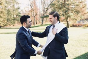 Kum receives his white wedding sash from the groom.