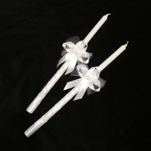 White Orthodox wedding candles dressed in ribbon and lace.