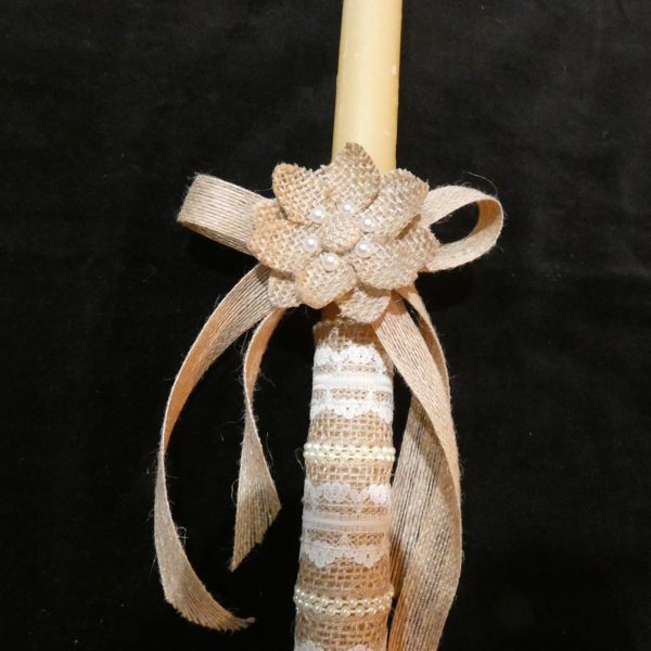Closeup of burlap ribbon and lace on an Orthodox wedding candle.
